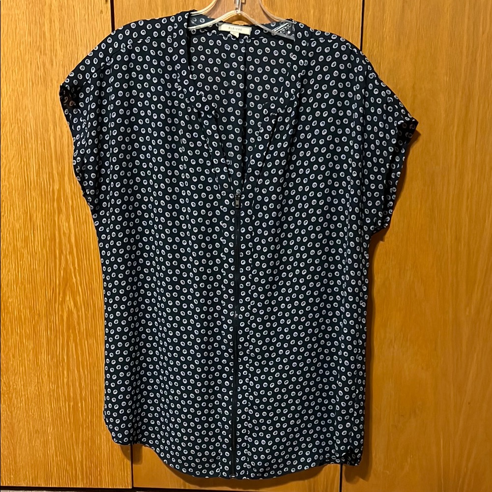 Pleione Cap Sleeve Top. V-Neck With Zipper Down Front. Cut Outs At Neck Line.